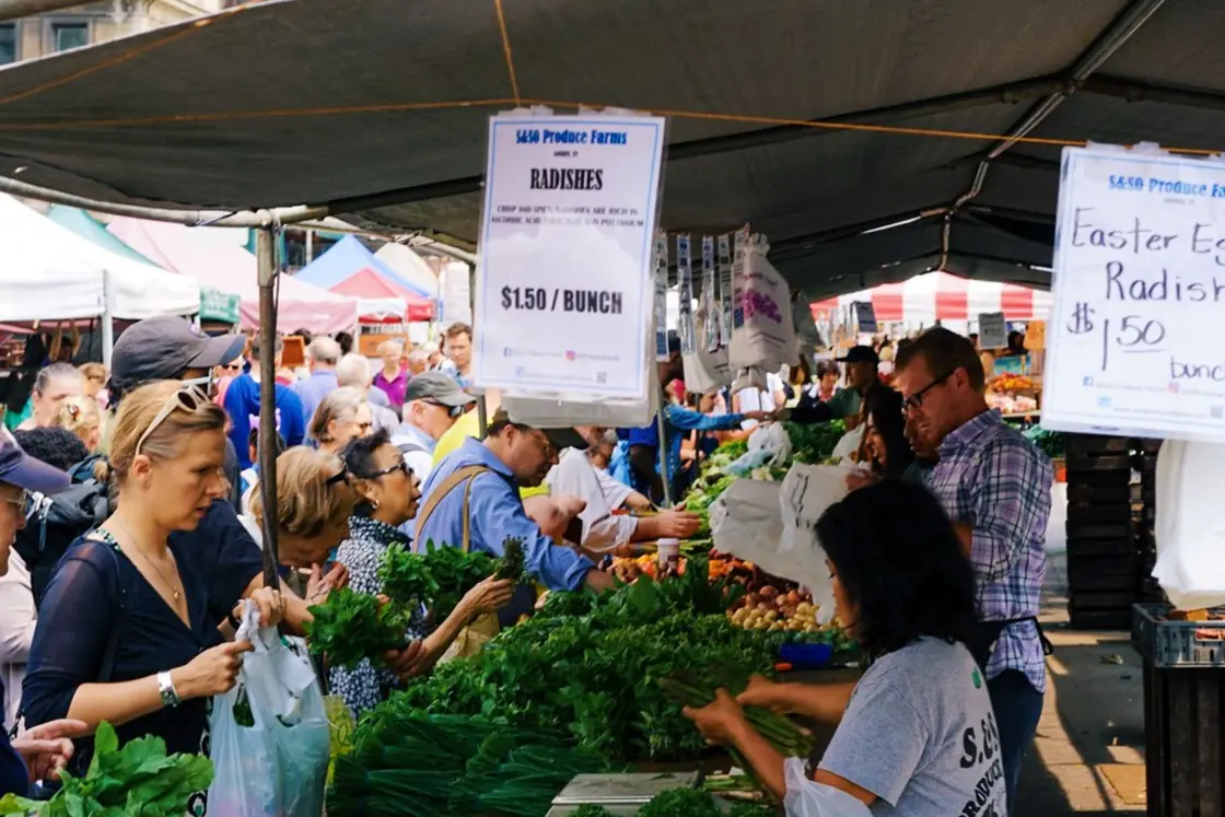 Vegetables arranged in crates at an outdoor market