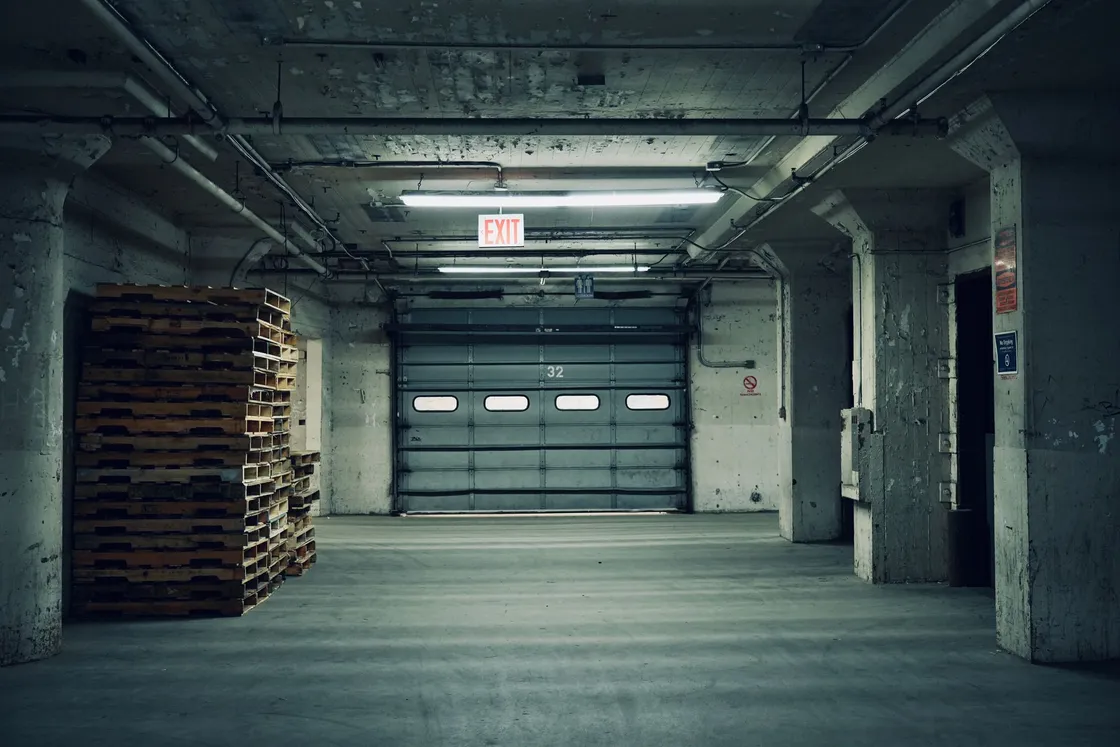 An industrial storage building with stacked wooden pallets
