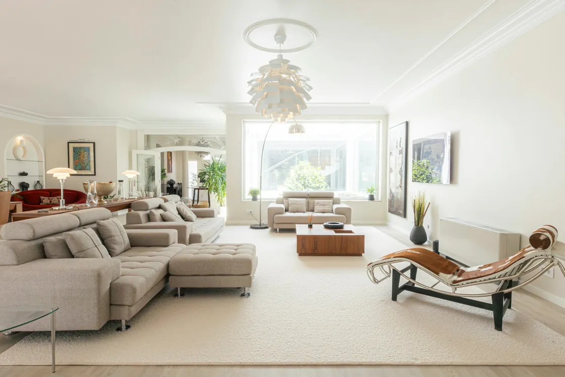 A bright living room with comfortable seating and large windows