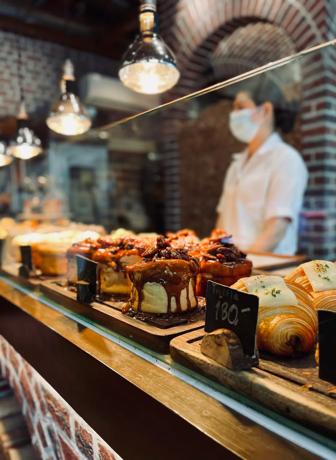 An assortment of glazed pastries behind a bakery counter