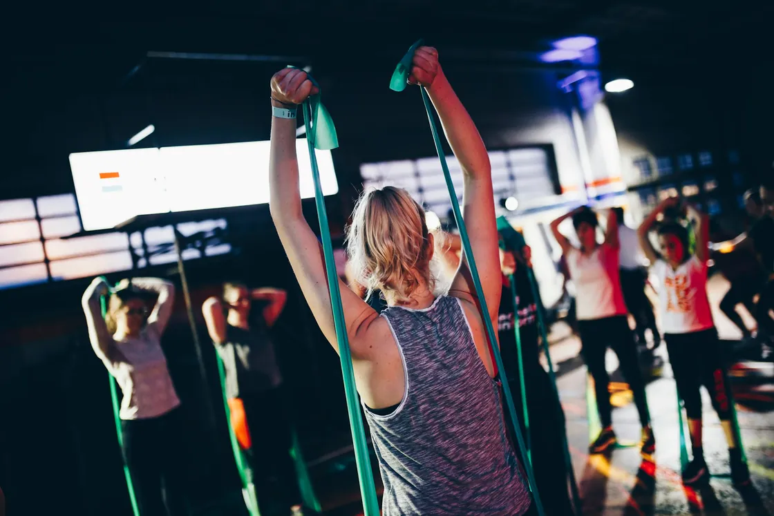 A group taking part in an exercise class inside a gym