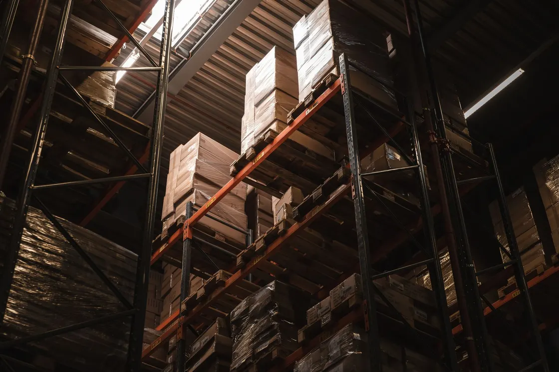 Cardboard cartons arranged on metal warehouse shelving