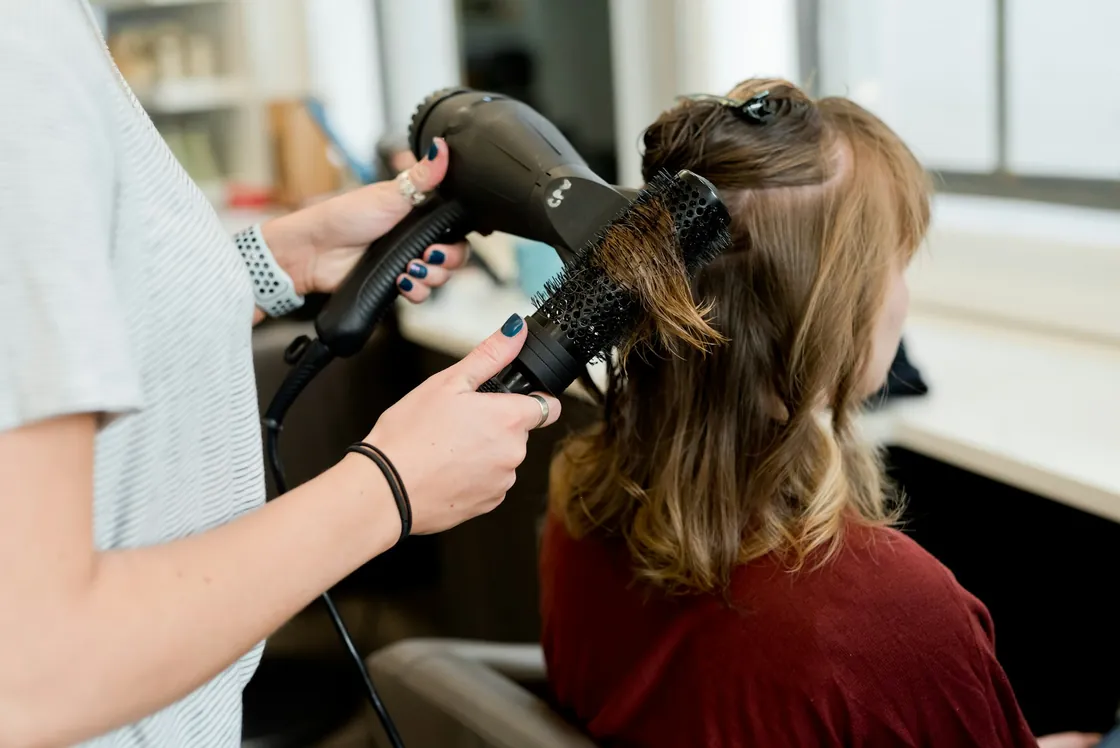 A stylist working on hair during an appointment