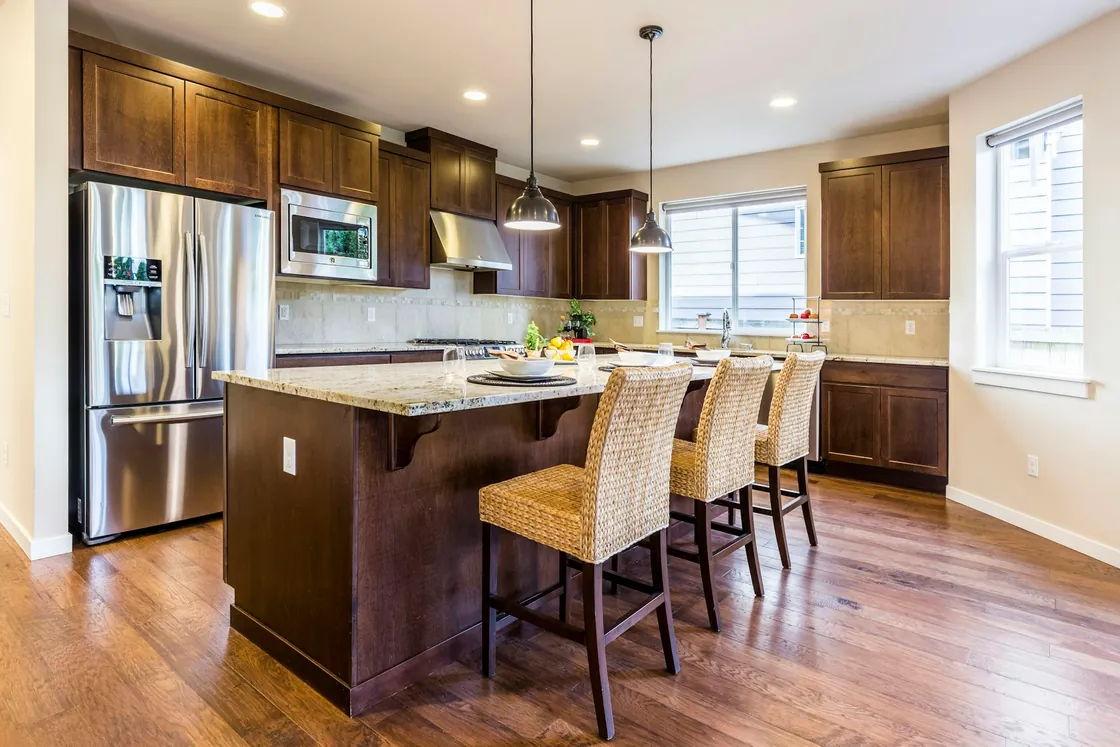 Timber kitchen cabinets and a white central island