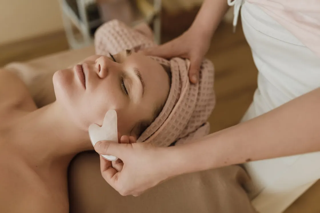A facial treatment taking place in a spa setting