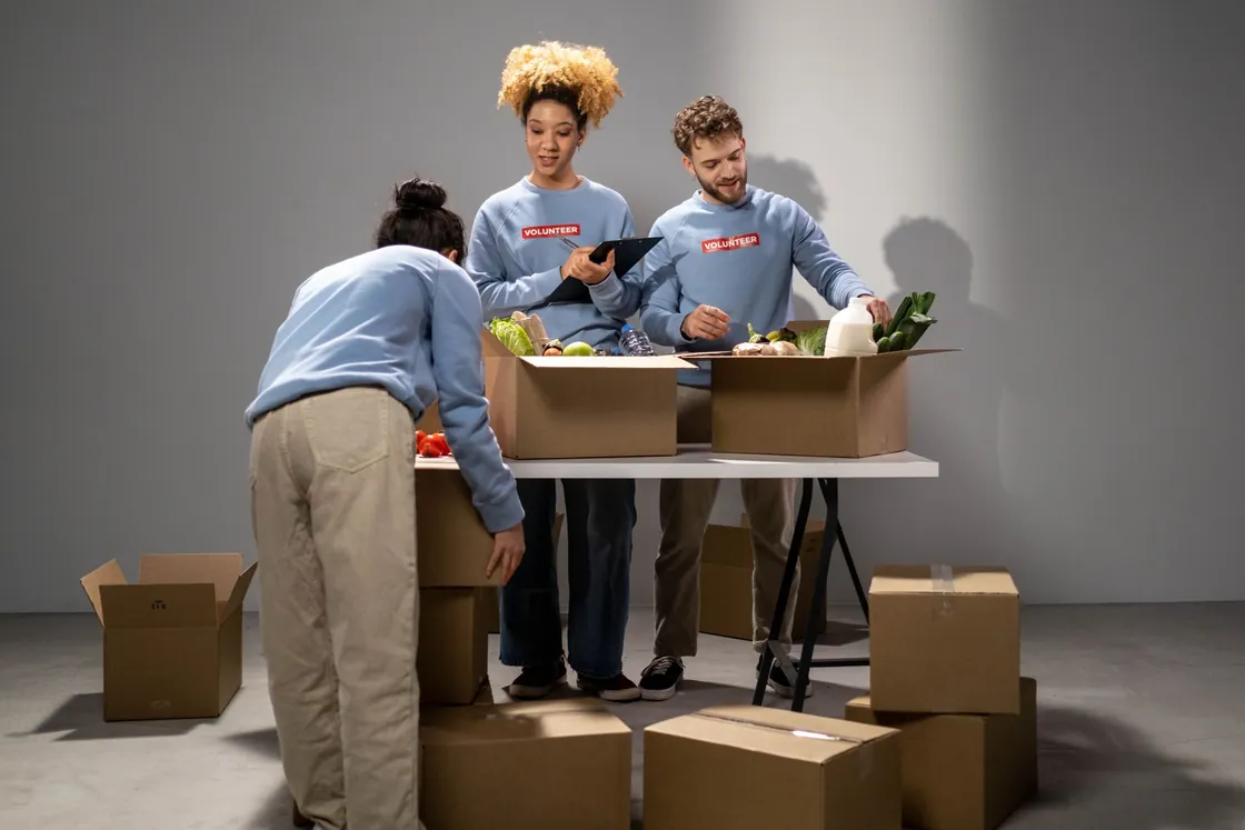 Volunteers organising food donations at a table