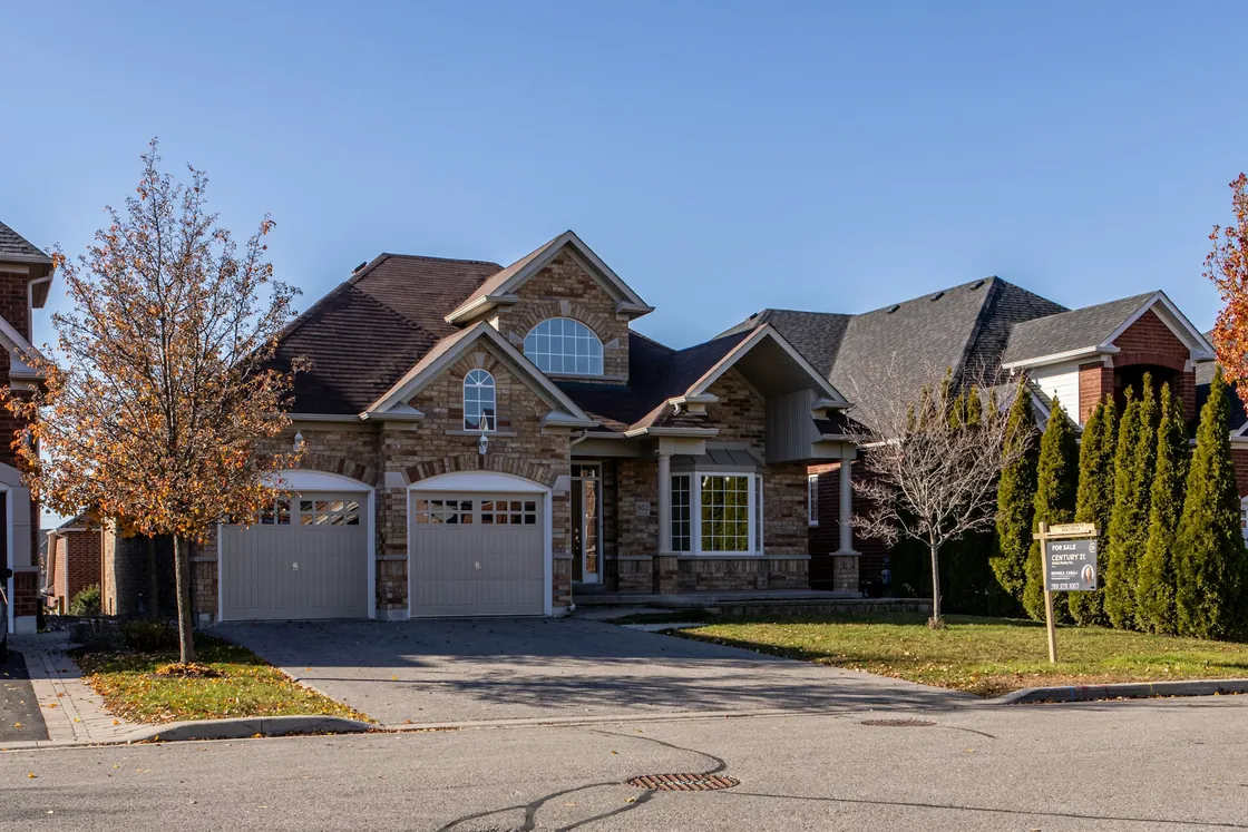 A brick house with a covered porch and driveway