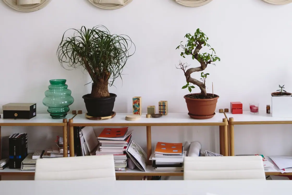 A furnished office room with a table and artwork