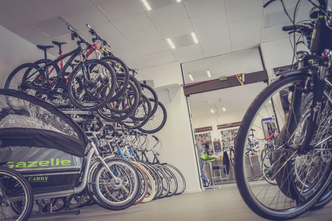 Rows of bicycles displayed on two levels inside a cycle shop