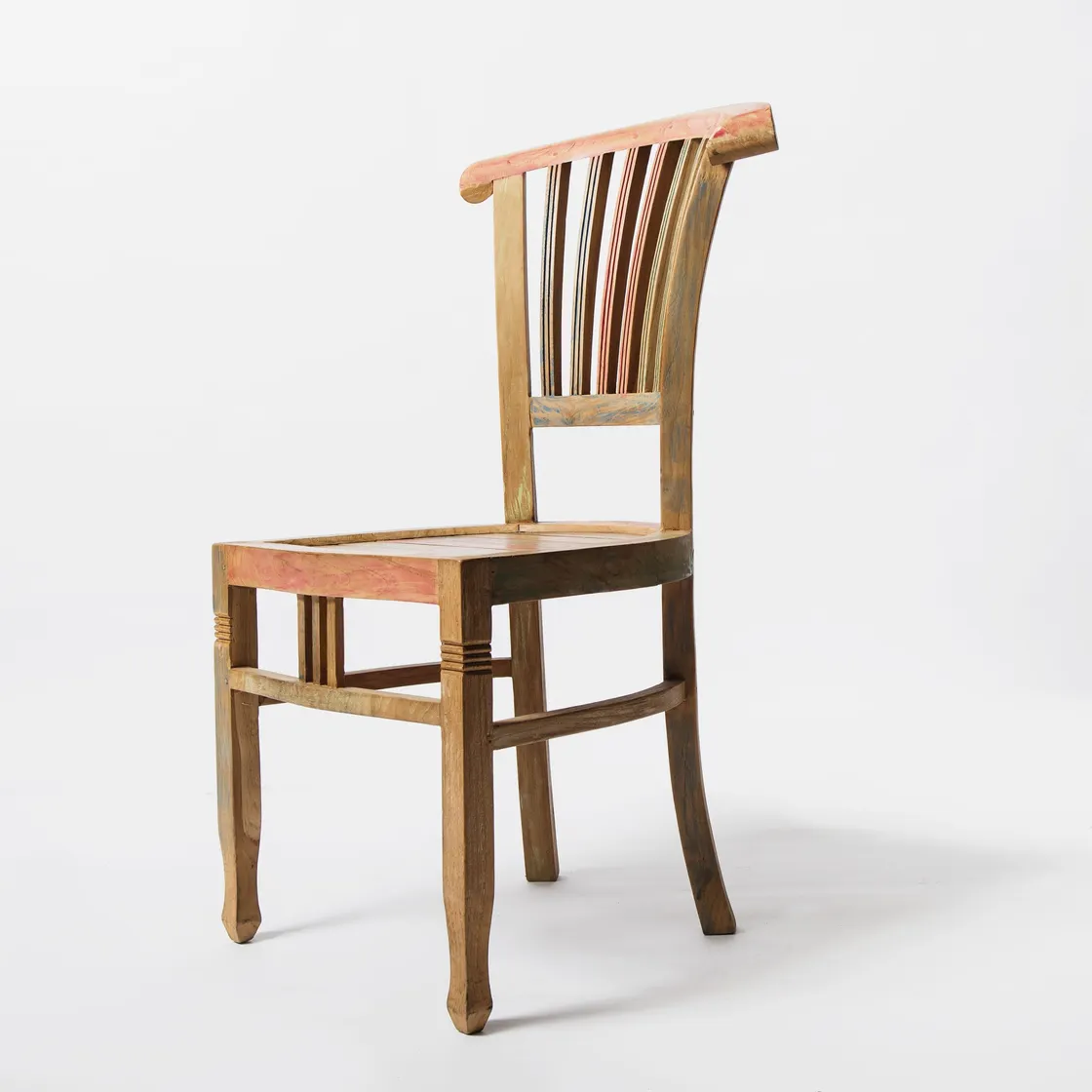 A brown wooden spindle-back chair with a solid seat