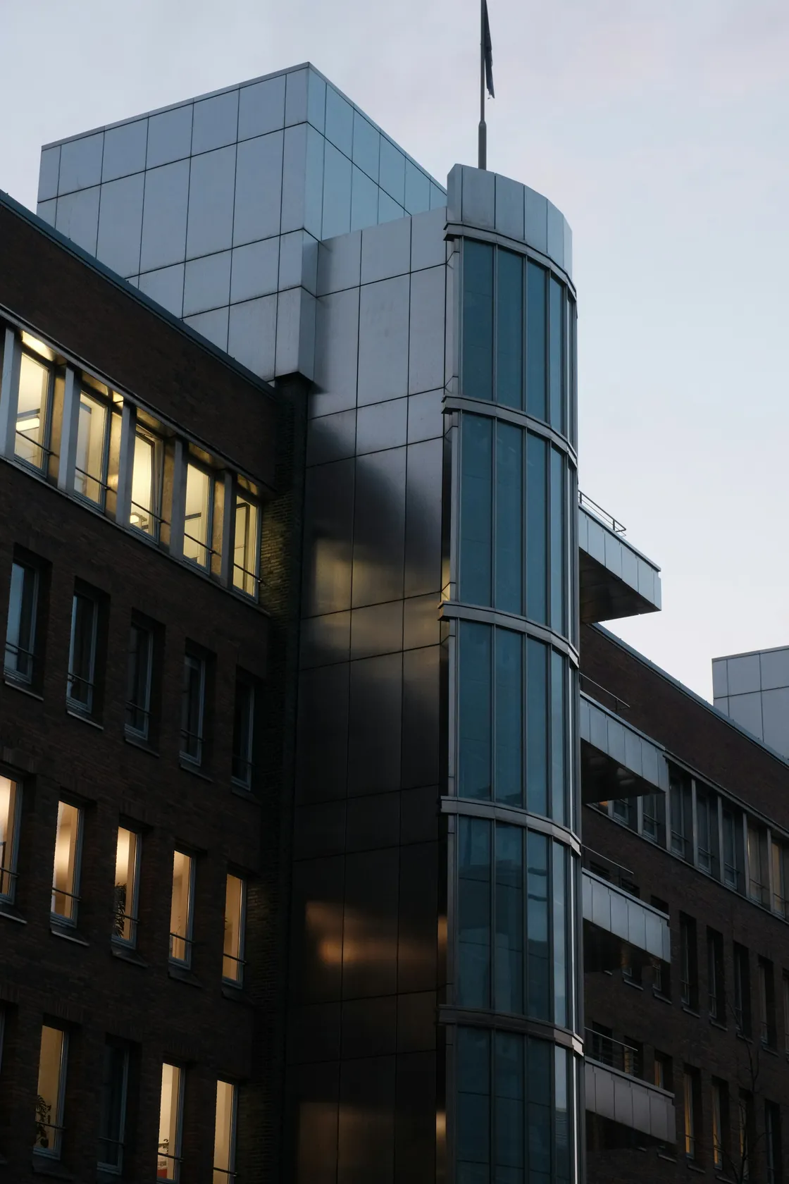A modern office building with brick and glass facades